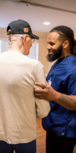 A caregiver assists a veteran.